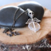 faceted quartz coin bead with skull and wings pendant