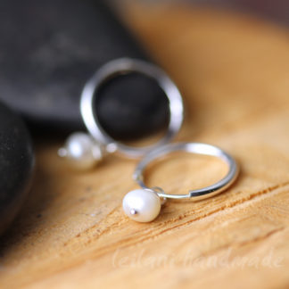 close up of tiny sterling silver dangle earrings with 3mm pearl dangle