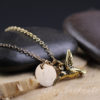gold hummingbird charm necklace with engraved initial