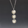 triple pearl necklace with hand domed disks