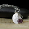 sterling silver disk engraved with daisy flower and swarovski crystal accent