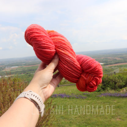 a person holding a skein of yarn
