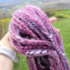 a hand holding a yarn