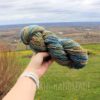 a hand holding a yarn