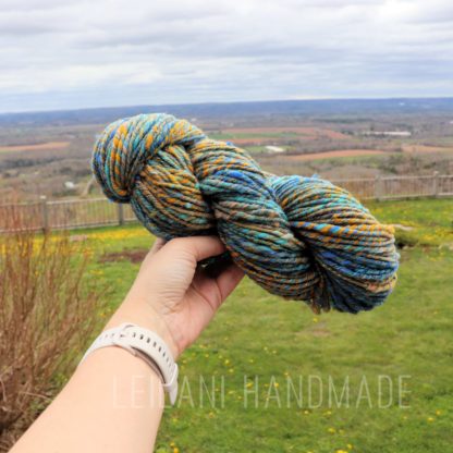 a hand holding a yarn