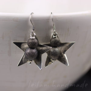 hand domed star earrings with metal stardust beads