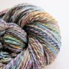 A close-up photo of a Stone hearth handspun yarn. The yarn is twisted and showcases various shades, including blue, green, purple, pink, and yellow. The texture appears soft and plush, highlighting the intricate blending of colors in a spiral pattern. The words LEILANI HANDMADE are visible faintly at the bottom