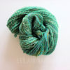 handspun yarn - green in color on a white/grey background - Springtime
