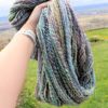 a hand holding a yarn