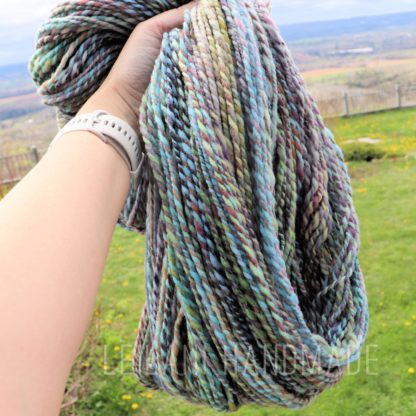 a hand holding a yarn