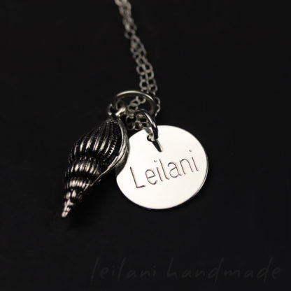 silver spindle shell necklace with an engraved letter disk that says Leilani