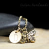 Gold butterfly keepsake necklace with engarved letter charm