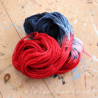 indie dyed worsted weight yarn red dark denim blue with aqua and light blue patches