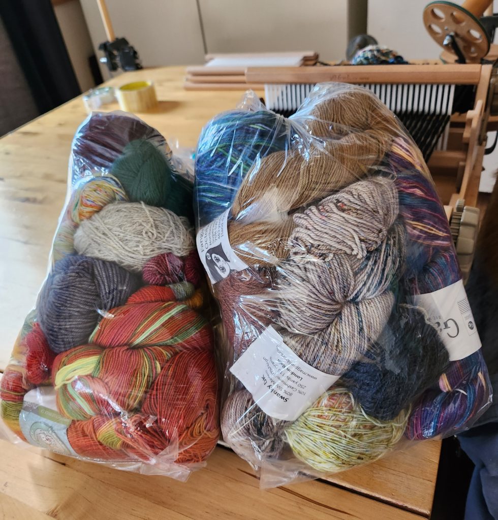 two clear bags of thirft store yarn