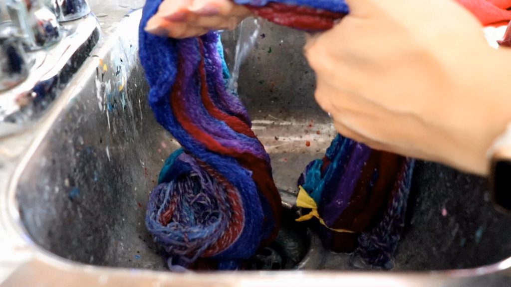 rinsing soap suds off soaked yarn